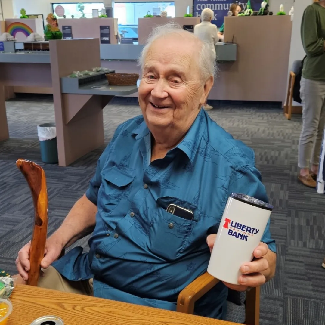 A longtime Liberty Savings Bank customer smiling in-branch